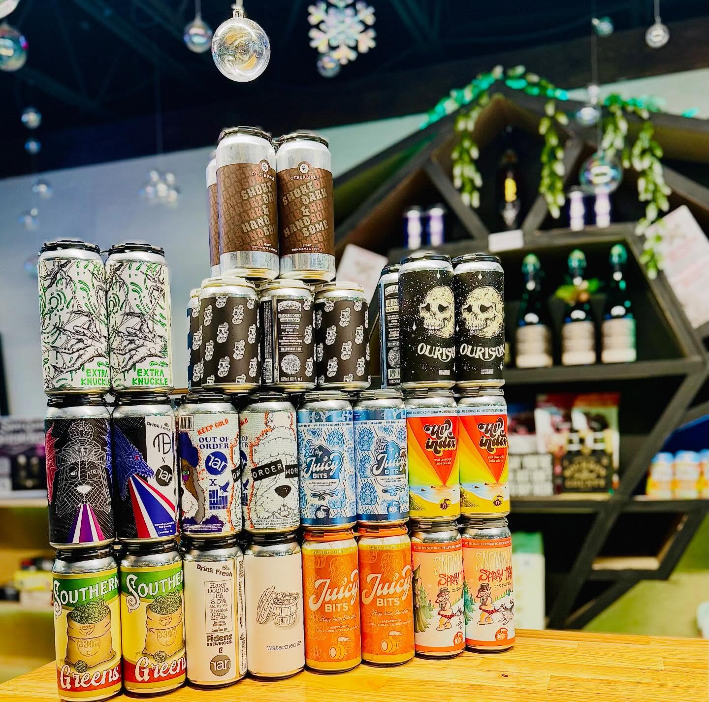 Stack of colorful craft beer cans at the Van Beers Bottle & Tap bottle shop in Melbourne FL during Beer Drop Fridays